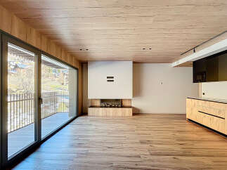 Experience luxury living in this stunning property featuring a modern fireplace and a sleek kitchen design.