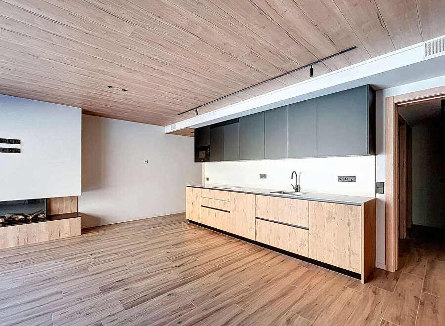 This modern kitchen boasts sleek cabinetry and a minimalist design, perfect for contemporary living.