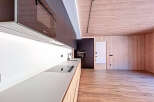 This modern kitchen boasts sleek, dark cabinetry and a minimalist design.