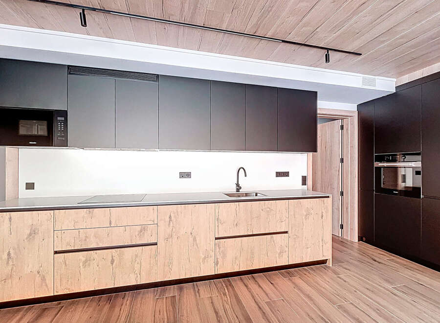 This modern kitchen boasts sleek cabinetry and a minimalist design, perfect for contemporary living.