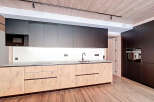 This modern kitchen boasts sleek cabinetry and a minimalist design, perfect for contemporary living.