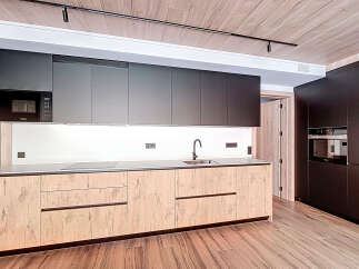 This modern kitchen boasts sleek cabinetry and a minimalist design, perfect for contemporary living.