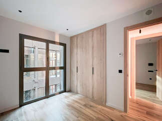 Discover modern living in this stylish property, featuring a spacious room with a large window that offers ample natural light.
