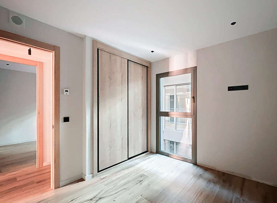 Discover this beautifully designed property featuring a modern interior with light wood flooring and a spacious layout.