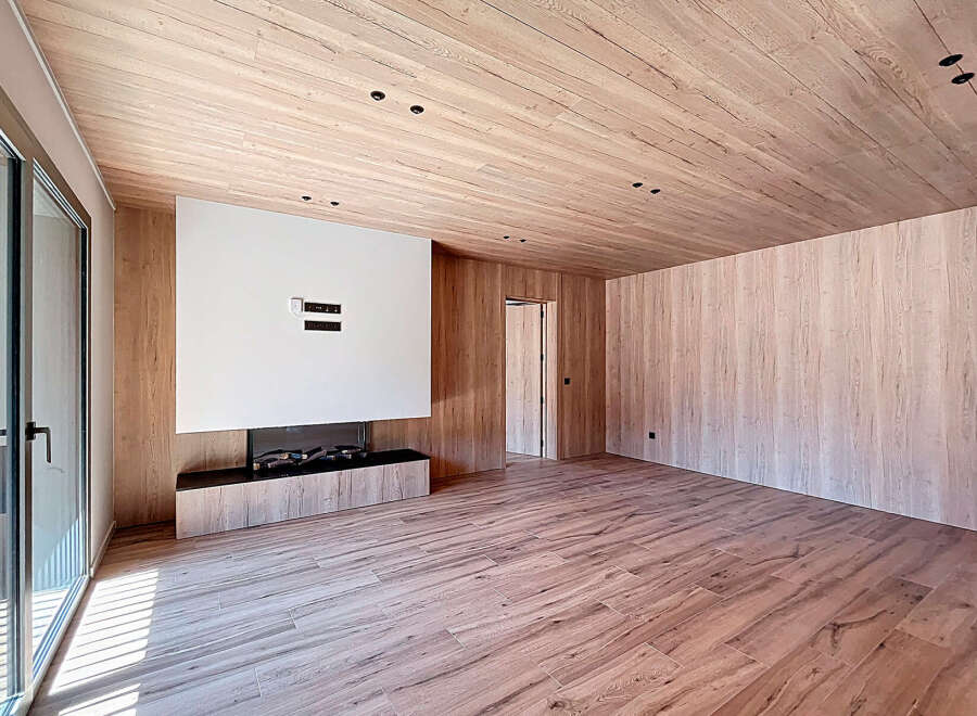 This stunning modern living space boasts a seamless blend of natural wood elements and contemporary design.