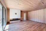 This stunning modern living space boasts a seamless blend of natural wood elements and contemporary design.