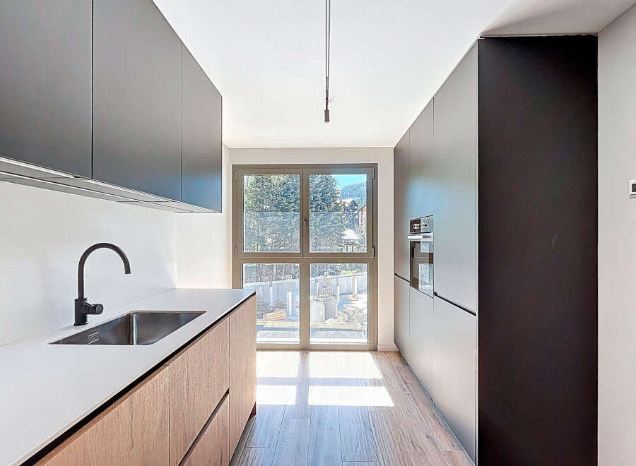 Experience modern elegance in this stunning kitchen! Featuring sleek cabinetry, a stainless steel sink, and a minimalist design, this space is perfect for both cooking and entertaining.