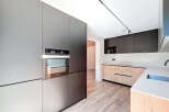 This modern kitchen boasts sleek, minimalist design with high-end appliances and ample storage.