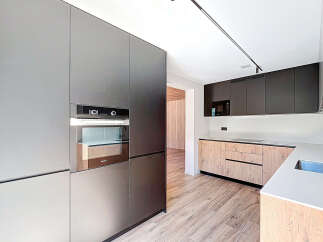 This modern kitchen boasts sleek, minimalist design with high-end appliances and ample storage.