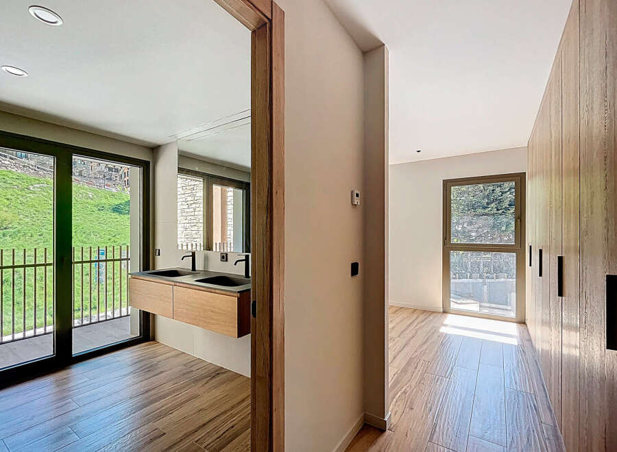 Discover modern luxury in this stunning property, featuring a sleek bathroom with a double sink and a spacious walk-in closet.
