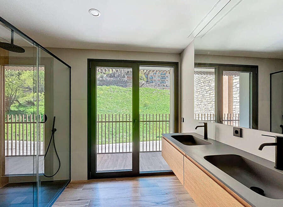 Experience luxury living in this stunning bathroom featuring a sleek, modern design.