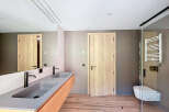 This modern bathroom boasts a sleek design with a double vanity featuring a minimalist aesthetic.