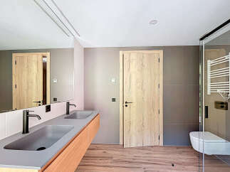 This modern bathroom boasts a sleek design with a double vanity featuring a minimalist aesthetic.