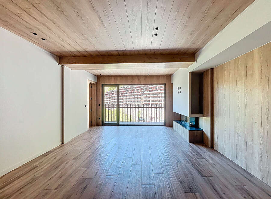 This stunning property boasts an open-plan living area with large windows offering breathtaking views.