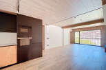 Stunning apartment boasting a modern kitchen with built-in appliances and sleek dark cabinetry.