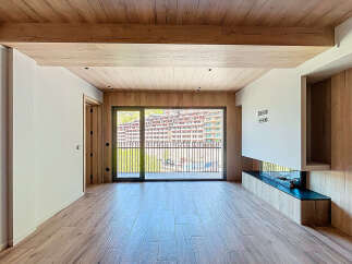 This stunning property boasts a spacious open-plan living area with large windows offering breathtaking mountain views.