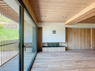 Stunning modern living space with floor-to-ceiling windows offering breathtaking views.