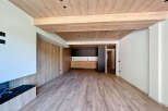 Stunning open-plan living space with wood beam ceilings and modern kitchen.