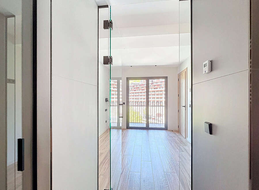 Step inside this stunning property featuring floor-to-ceiling glass doors that bathe the interior in natural light and offer breathtaking views.