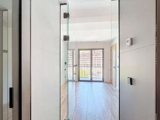 Step inside this stunning property featuring floor-to-ceiling glass doors that bathe the interior in natural light and offer breathtaking views.