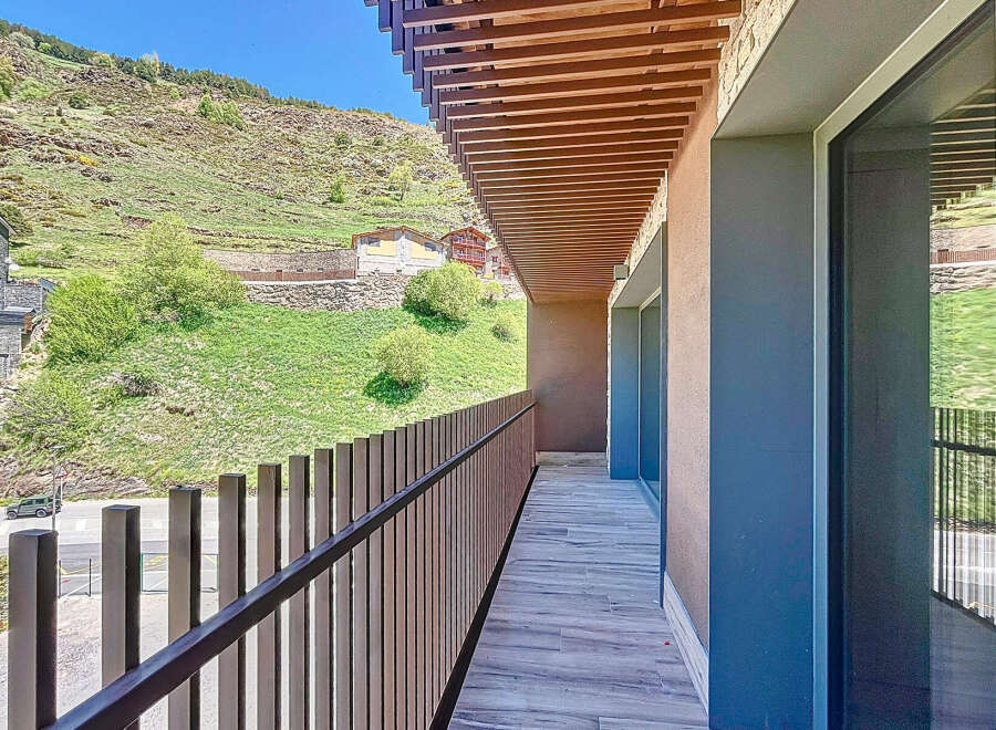 This stunning property boasts a spacious balcony with breathtaking mountain views.