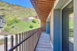 This stunning property boasts a spacious balcony with breathtaking mountain views.