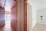 This stunning property boasts two spacious rooms with sleek wooden doors and modern light fixtures.