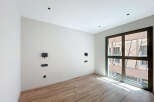 Bright and airy room with large window offering ample natural light.