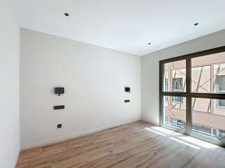 Bright and airy room with large window offering ample natural light.