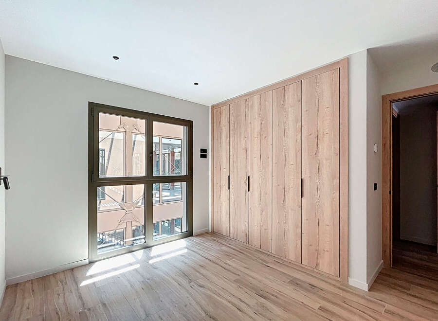 Bright and airy bedroom with large window offering ample natural light.
