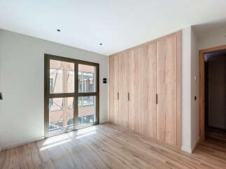 Bright and airy bedroom with large window offering ample natural light.
