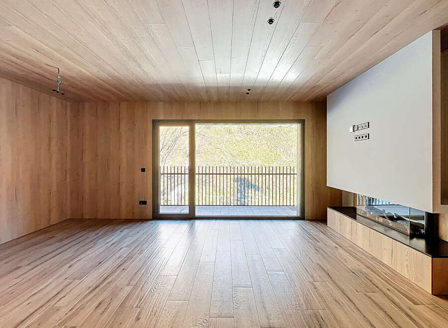 This stunning property boasts a modern interior with exquisite wooden finishes throughout.