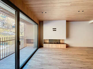 Experience luxury living in this stunning property, featuring a modern design with a cozy fireplace and expansive windows.
