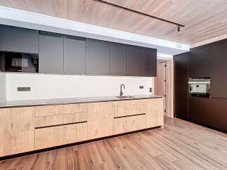This modern kitchen boasts sleek, dark cabinetry and a stylish design.