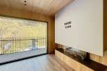 Experience luxury living in this stunning property with a modern fireplace and expansive windows.