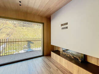Experience luxury living in this stunning property with a modern fireplace and expansive windows.