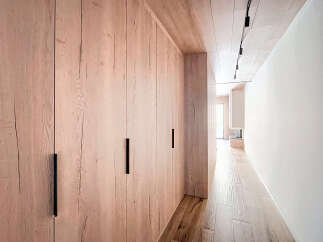 This stunning property features a beautifully designed hallway with custom wooden cabinetry.