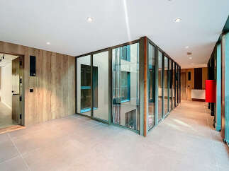 Discover modern elegance in this stunning property, featuring sleek glass walls and a contemporary design.