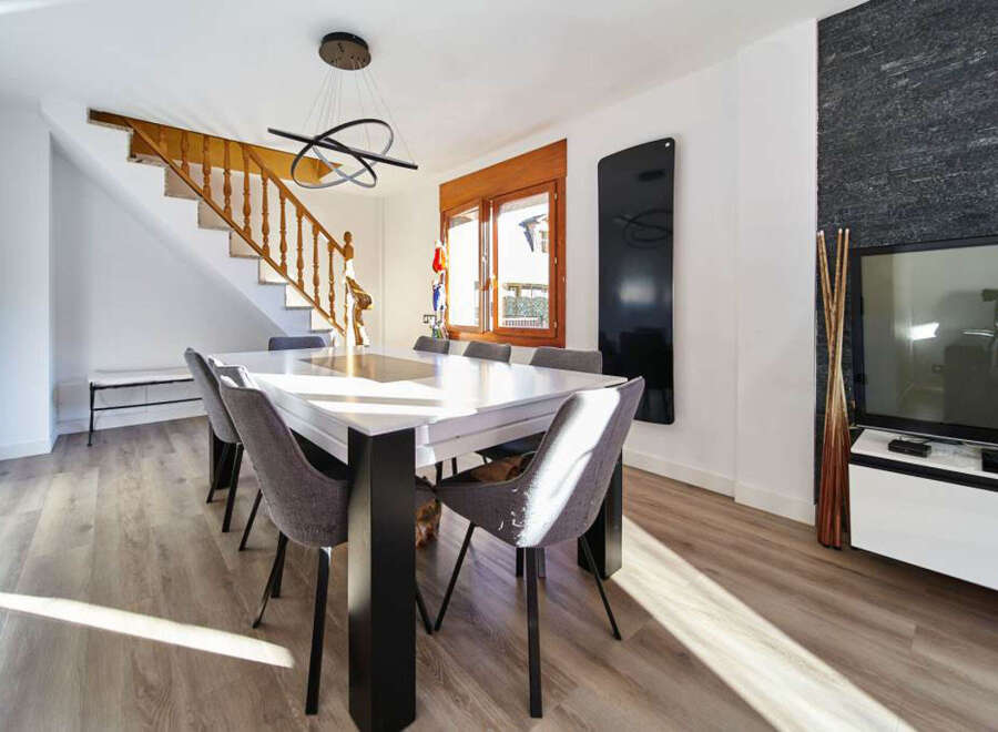 Stunning dining area with modern table and chairs, bathed in natural sunlight.