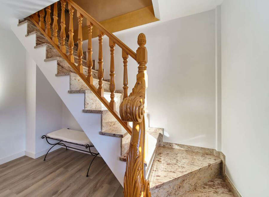 This stunning property boasts a grand staircase with exquisite wooden banisters and granite steps, adding a touch of elegance to the home.