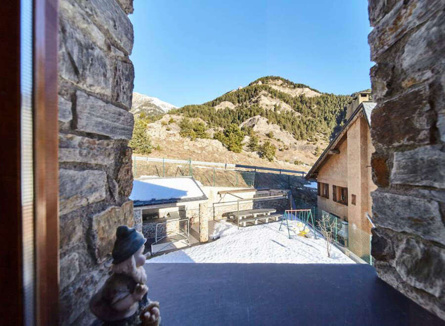 Mountain view from a charming stone house.