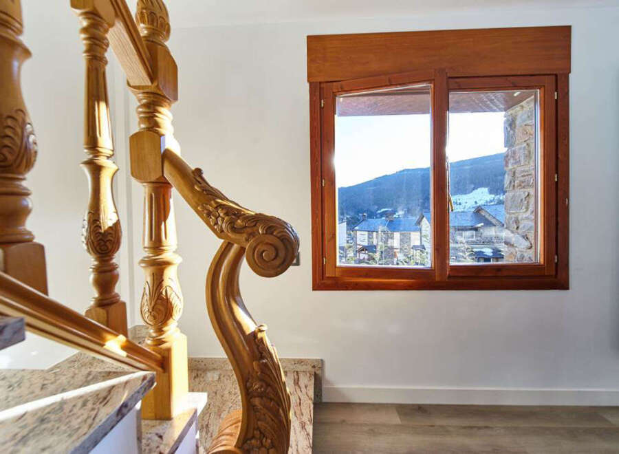 This stunning property boasts a grand wooden staircase with intricate detailing, adding a touch of elegance to the home.