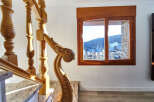 This stunning property boasts a grand wooden staircase with intricate detailing, adding a touch of elegance to the home.
