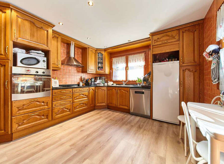 This stunning kitchen boasts beautiful wood cabinets, modern appliances, and a spacious layout.
