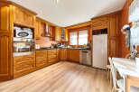 This stunning kitchen boasts beautiful wood cabinets, modern appliances, and a spacious layout.