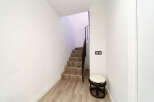 Modern hallway with stylish wooden flooring and a contemporary staircase leading upstairs.