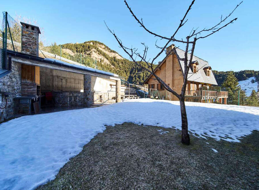Mountain chalet with stunning views and outdoor BBQ area.