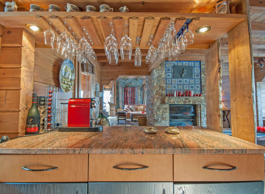 This stunning log cabin boasts a gourmet kitchen with granite countertops and custom cabinetry.