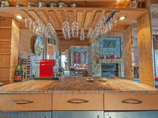 This stunning log cabin boasts a gourmet kitchen with granite countertops and custom cabinetry.