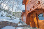 This stunning log cabin boasts a beautiful wooden exterior, perfect for a cozy winter getaway.